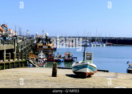 SCARBOROUGH, YORKSHIRE, UK. MAY 09, 2016. A local fishing boat moored on the slipway of the busy harbor at Scarborough Stock Photo