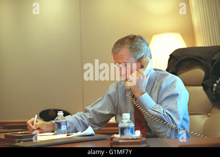 U.S President George W. Bush confers with staff via telephone aboard Air Force One following the terrorist attacks September 11, 2001 while en route to Barksdale Air Force Base in Louisiana. Stock Photo