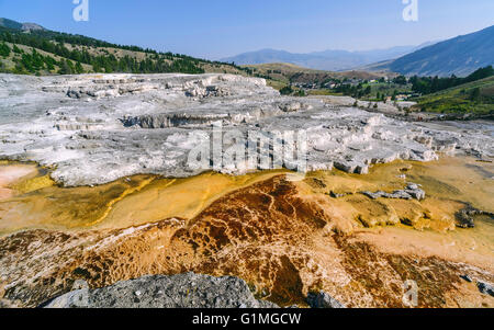 Calcium Carbonate deposits from hot springs in the heart of Yellowstone National Park with Mammoth in the background. Stock Photo