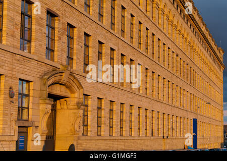 Late evening sun lights up the wall of Lister's Mill in Manningham, Bradford England, UK Stock Photo
