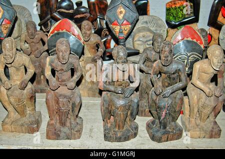 Ghana, West Africa, African Wood Arts. Wooden hand crafted figures and African masks, on sale at an art shop in Ghana Stock Photo