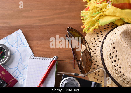 Planning holiday beach tourism. Beach items on brown wooden table. horizontal composition. Elevated view Stock Photo