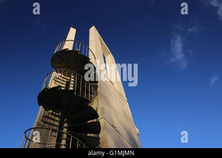 Lookout tower with spiral staircase seen from below. The sky is darkened due to the use of a polarization filter. Stock Photo