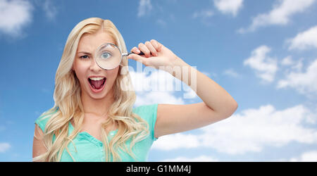 happy young woman with magnifying glass Stock Photo