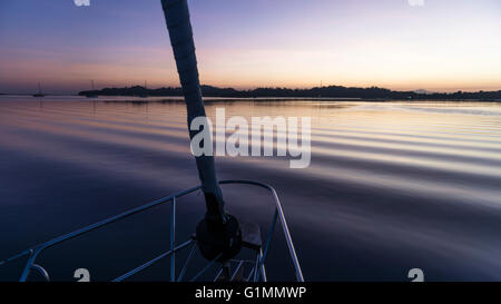 View towards Musket Cove at dawn from the anchorage near the island resort. Fiji Stock Photo