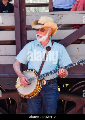 Banjo player entertains tourists on a train of the Kettle Valley Steam Railway, near Summerland BC Canada. Stock Photo