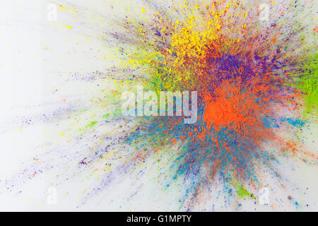 Color explosion concept. Colorful Holi powder exploding on white background with copy space. Stock Photo