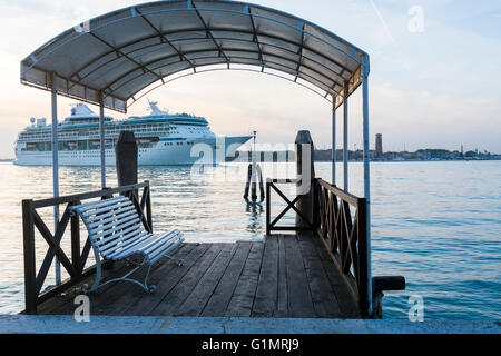 Cruise ship passing jetty on the Lido in the afternoon, Venice in the background Stock Photo