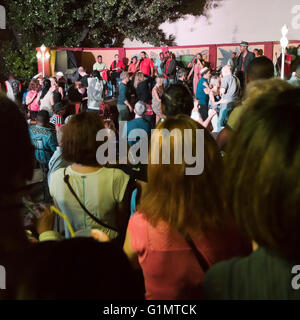 Square view of people dancing to a salsa group at Casa de la Mœsica in Trinidad, Cuba. Stock Photo