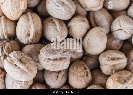 Walnuts in shells on a market Stock Photo