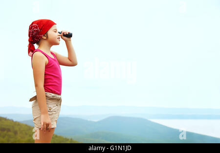Girl with spyglass Stock Photo