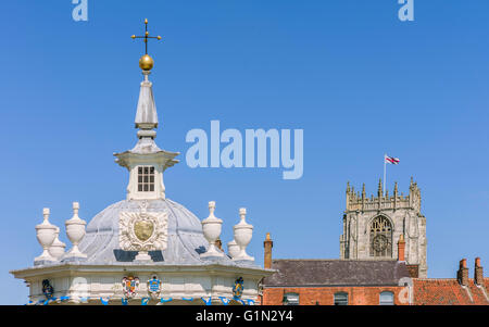 The ornate top of the bandstand, rooftops, and part of St Mary's church with flag of St George flying against a blue sky Stock Photo