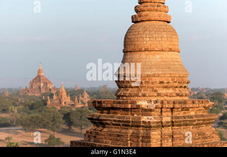 Small stupa atop the terrace of Pyathada Paya with Htilominlo Temple in the background, Bagan, Burma - Myanmar Stock Photo