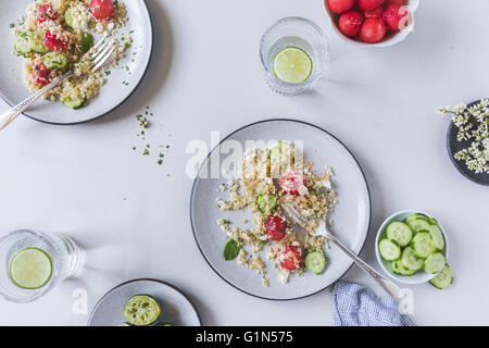 Two half eaten plates with watermelon bulgur salad are photographed from the top view. Stock Photo