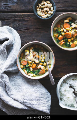Coconut curried chickpeas with carrots & cashews Gluten-free, vegan. Stock Photo