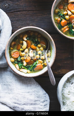 Coconut curried chickpeas with carrots & cashews Gluten-free, vegan. Stock Photo