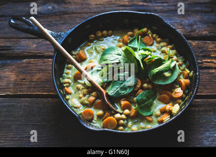 Coconut curried chickpeas with carrots & cashews Gluten-free, vegan. Stock Photo