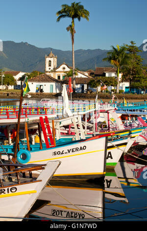 Santa Rita catholic church in Paraty ( or Parati ), a preserved Portuguese colonial and Brazilian Imperial town located on the Costa Verde ( Green Coast ), a lush, green corridor that runs along the south coastline of the state of Rio de Janeiro, in Brazil - Paraty has become a popular tourist area renowned for the historic constructions and is known for the cobblestone-paved streets throughout the Historic Center District. Stock Photo