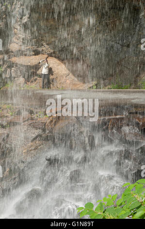 Woman photographer at Bridal Veil Falls near Highlands, NC. Stock Photo