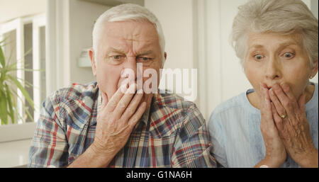 Shocked senior couple looking Stock Photo