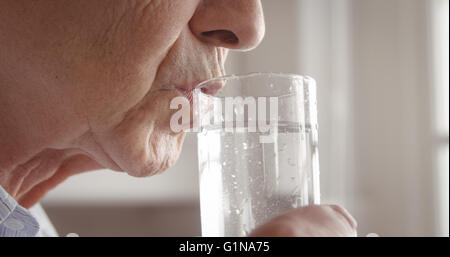 Senior woman drinking water glass Stock Photo