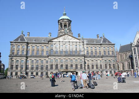 Tourists in front of the 17th century Paleis op de Dam  - Royal Palace of Amsterdam on Dam square Stock Photo