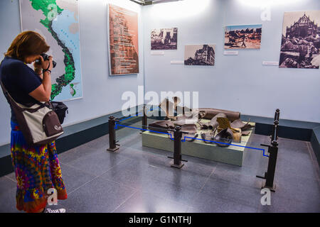 (160517) -- HO CHI MINH CITY, May 17, 2016 (Xinhua) -- A tourist takes photos at the War Remnants Museum in Ho Chi Minh City, Vietnam, May 16, 2016. The War Remnants Museum is located in District 3 of Ho Chi Minh City. Opened in 1975, the museum is specialized in researching, collecting, preserving and exhibiting the remnant proofs of Vietnam war crimes and their consequences, which calls for people to say no to wars and say yes to peace. With the annual reception capacity of more than 500,000 visits, the museum has become one of the well-known cultural and tourist sites for both Vietnamese an Stock Photo