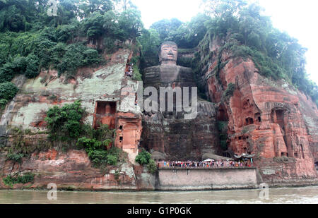 May 17, 2016 - Leshan, Leshan, CHN - Leshan, China - May 17 2016: (EDITORIAL USE ONLY. CHINA OUT) The Leshan Giant Buddha is a 71-metre (233 ft) tall stone statue, built during the Tang Dynasty. It is carved out of a cliff face that lies at the confluence of the Minjiang, Dadu and Qingyi rivers in the southern part of Sichuan province in China, near the city of Leshan. The stone sculpture faces Mount Emei, with the rivers flowing below his feet. It is the largest stone Buddha in the world and it is by far the tallest pre-modern statue in the world. It is on UNESCO's list of world natural and c Stock Photo