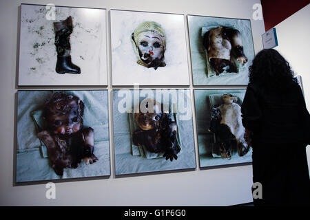 Somerset House, London, UK - 18 May 2016. A woman looks at A G Galerie's photographs. Photo London which opens on 19 May 2016 in Somerset House brings together 80 of the world's leading galleries in a major international fair. Photo London was created to give London an international photography event befitting the city's status global cultural capital. Credit:  Dinendra Haria/Alamy Live News Stock Photo