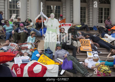 Various environmental groups including the Sierra Club joined forces at city hall in NYC to remind Mayor de Blasio to push forward with his promise to switch the city over to renewable energy sources. The ended the press conference with a die-in for dramatic effect. Stock Photo