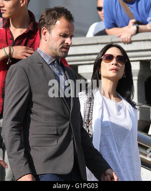 LONDON, UK - JULY 10, 2013: Lucy Liu and Jonny Lee Miller sighting on set filming Elementary in Trafalgar Square in London Stock Photo