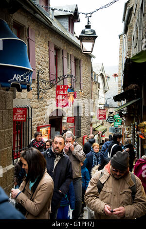 Crowds on main street Grande Rue in Mont Saint Michel St Michael's Mount, Normandy, France Stock Photo