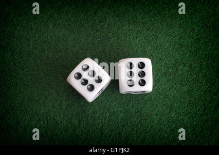 Two dices on a green background. Close up. Stock Photo