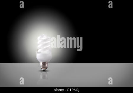 One espiral light bulb on white table with black background. Front view. Horizontal composition Stock Photo