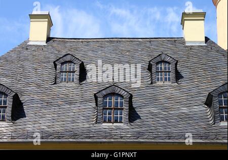 Mansard windows in a old style roof Stock Photo
