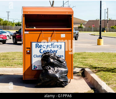 A clothing recycling center bin in Oklahoma City, Oklahoma, USA. Stock Photo