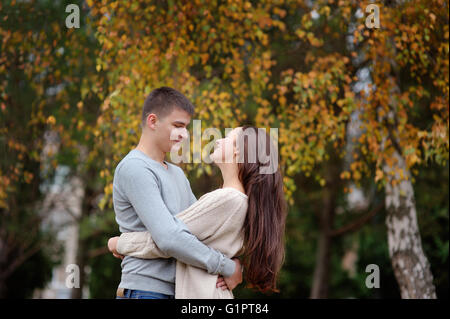 happy young couple embracing outdoor in the autumn park Stock Photo