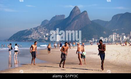 Rio de Janeiro, Brazil - 11 June, 2014: Playing football on Ipanema beach Stock Photo