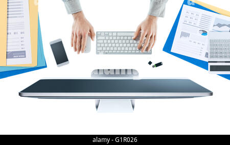 Businessman working at office desk and using a computer, hands top view, white background Stock Photo