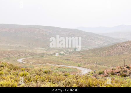 A wet Nuwekloofpas (new valley pass) descending into the Baviaanskloof (baboon valley) during a rain storm Stock Photo