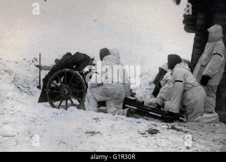 German Light Infantry Gun with crew in Snow Camouflage Eastern Front 1942 Stock Photo