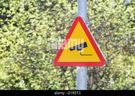 CCTV sign on a post with greenery in the background. Security camera video surveillance symbol Stock Photo