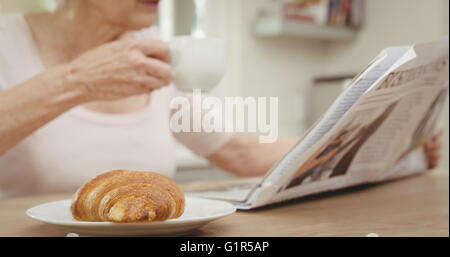 Senior woman drinking coffee Stock Photo