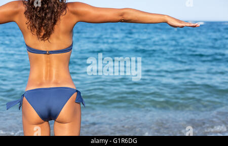 Woman enjoying warm summer day at the seaside. Stock Photo