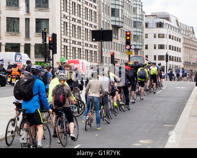 Cyclists on North-South Cycle Superhighway on Farringdon St undertaking  the evening commute from the centre of the city of London to cycle home. Stock Photo