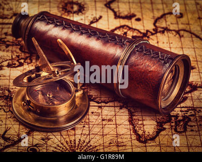 vintage compass and spyglass on old world map. copy space Stock Photo ...