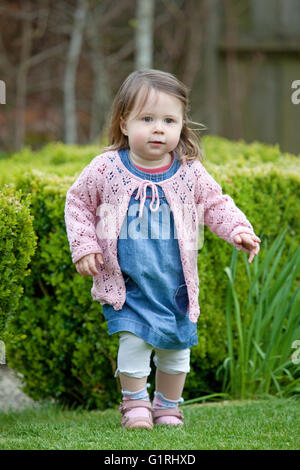toddler running in garden Stock Photo