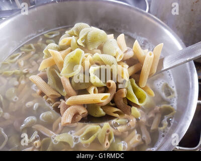 Different kind of colorful spelt pastas, boiling in a casseroll Stock Photo