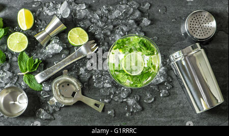 Summer drink mojito with lime, mint and ice. Top view. Glass of cocktail. Stock Photo