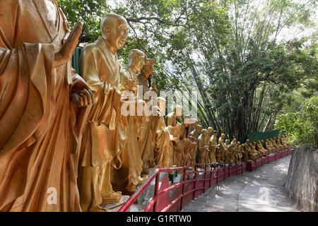 Lifesize, gilded figures of Arhat, Buddhist Sage, on the way to the Monastery of 10,000 Buddhas, Sha Tin, New Territories Stock Photo